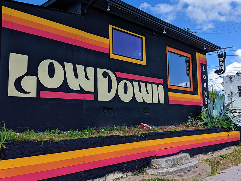 low down lounge painted sign on side of building austin tx