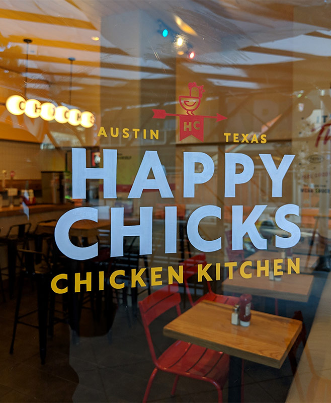 window sign for happy chicks chicken kitchen austin tx